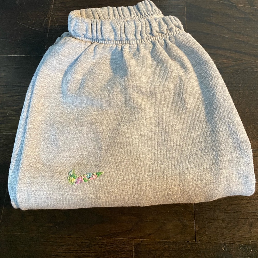 Grey Embroidered Nike sweatpants.